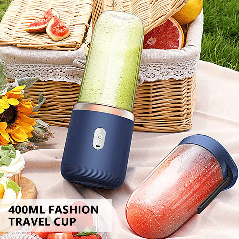 Tragbarer Mixer mit grünem Smoothie, Mango, Erdbeeren und Picknickkorb.