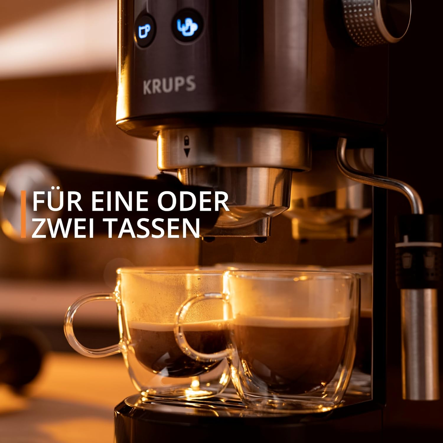 Macchina per caffè espresso con due tazze di caffè in vetro. Testo: PER UNA O DUE TAZZE. Sfondo sfocato.