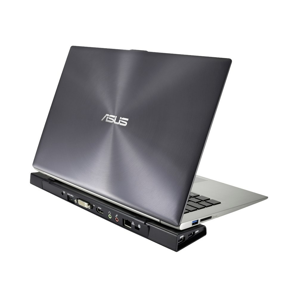 Laptop Asus su dock nero, porte visibili. Laptop argento, dock nero con porte.