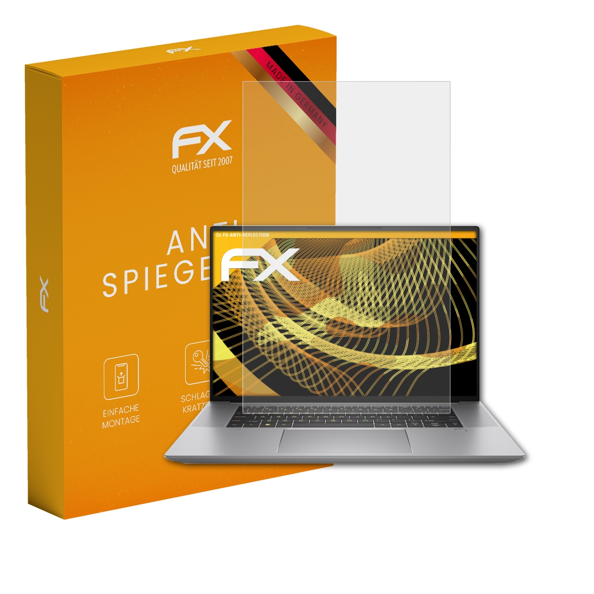 Eine orangefarbene Schachtel und ein Displayschutz über einem Laptop. Der Laptop zeigt ein goldenes Design.
