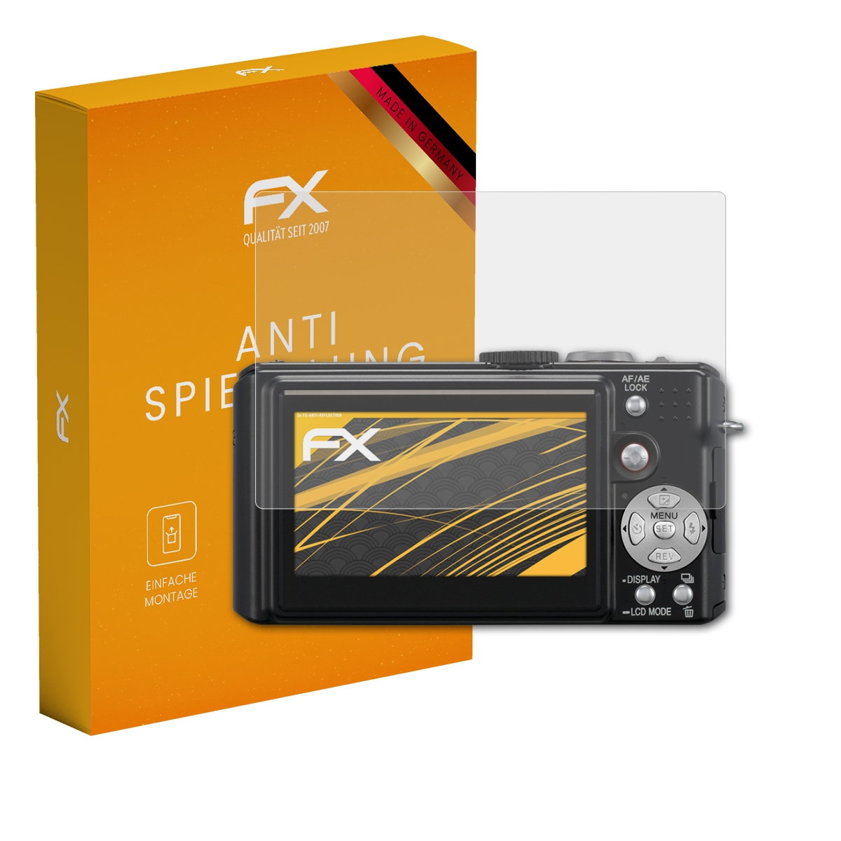 Eine orangefarbene FX-Box neben einer schwarzen Digitalkamera mit einer auf dem Display angebrachten Displayschutzfolie.