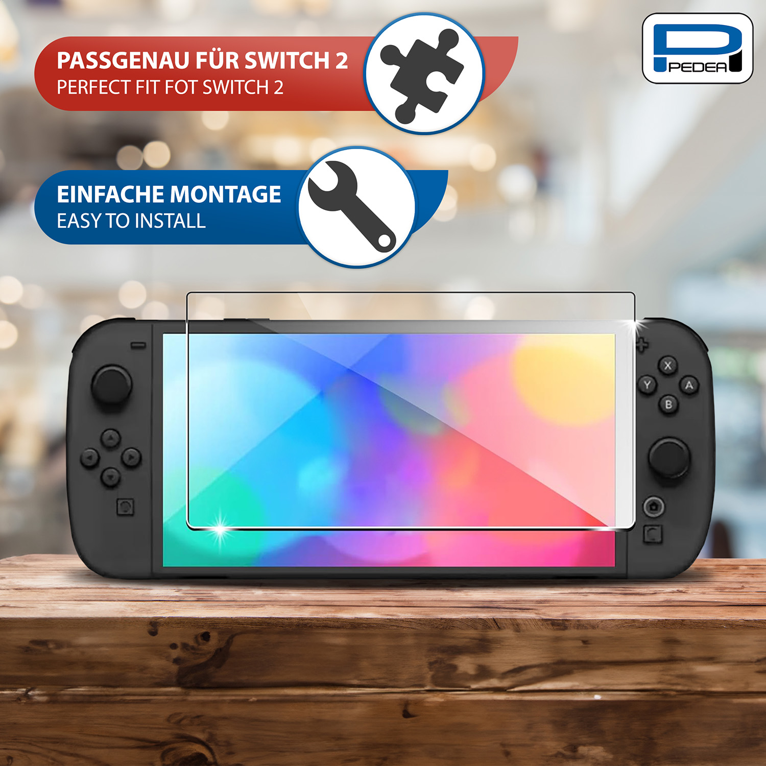 Uno Switch 2 con protezione schermo, tavolo di legno e grafica per installazione e perfetta aderenza.