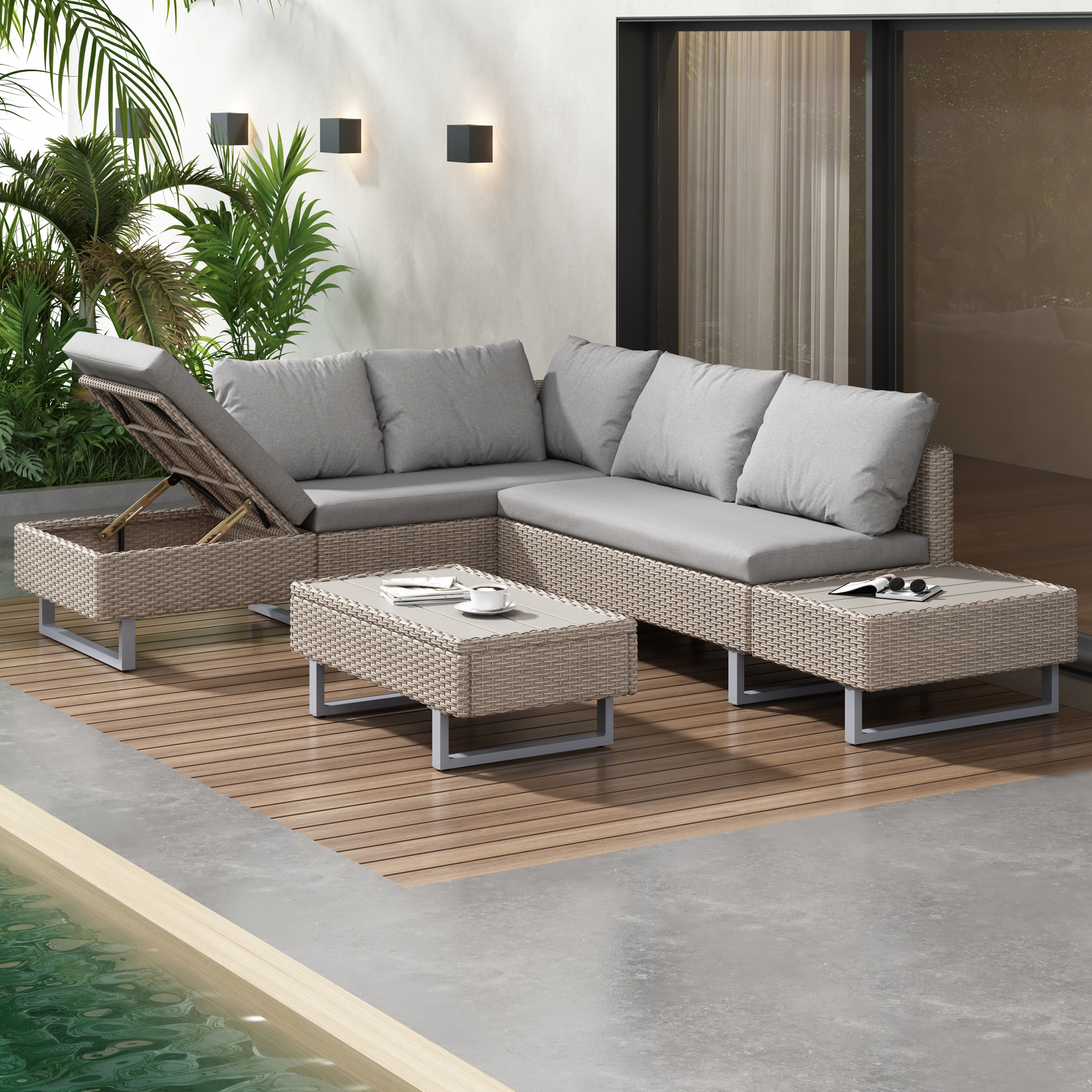 Terrassenmöbel. Graue Sofas und Couchtische. Holzterrasse und Pflanzen.