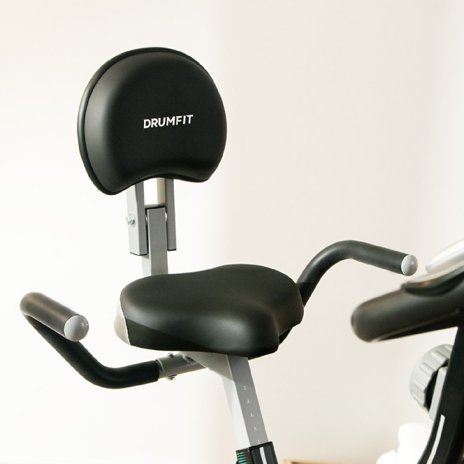 Primer plano de un asiento de bicicleta de ejercicio negro con respaldo.