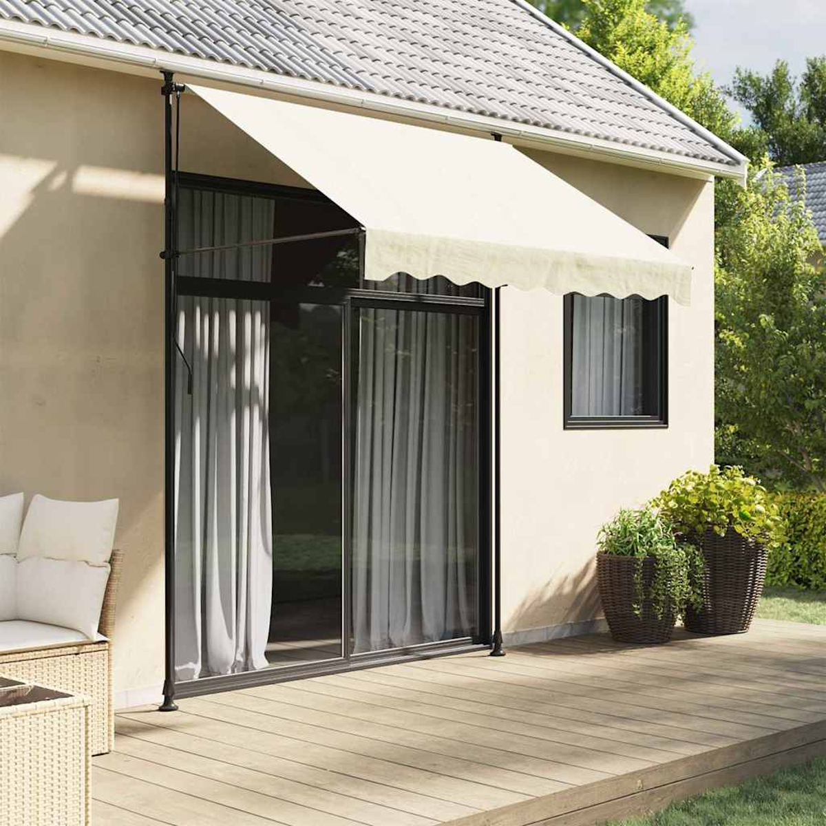 Beige Markise, an einem Haus außen. Schwarzer Rahmen, Glastüren, Holzterrasse. Pflanzen rechts.