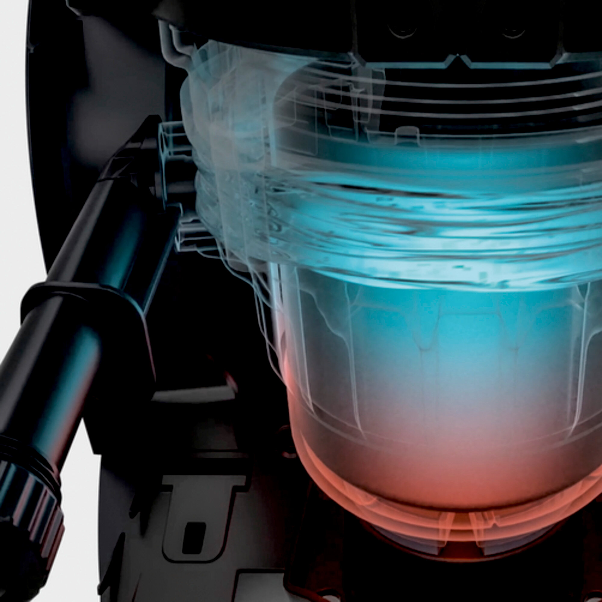 Zbliżenie przezroczystego pojemnika z cieczą. Pojemnik znajduje się wewnątrz większego czarnego urządzenia.