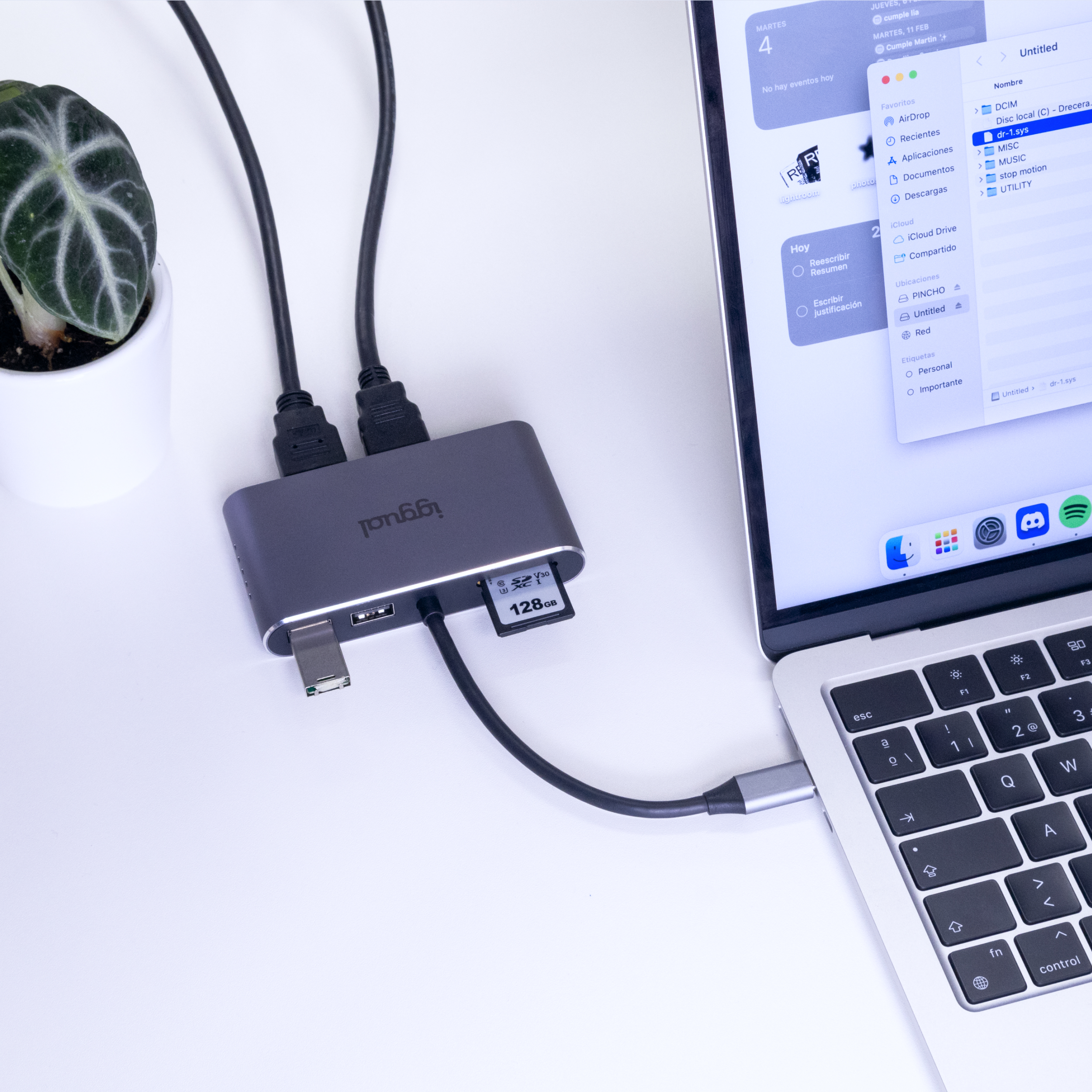 Laptop podłączony do adaptera. Adapter ma porty USB, HDMI i kartę SD. Notatnik na wyświetlaczu.