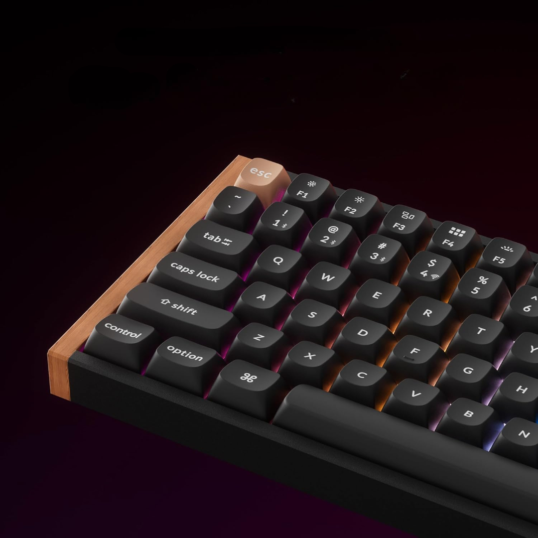 Primo piano di una tastiera con tasti neri, lettere bianche e cornice in legno. Il tasto ESC è beige.