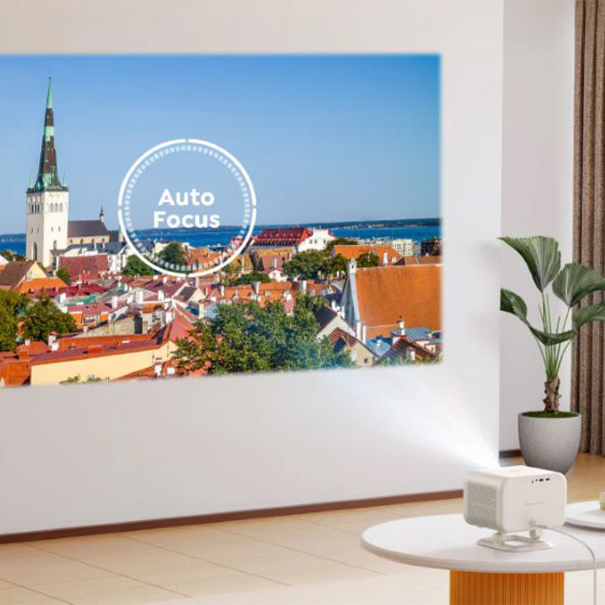 Projektor wyświetlający obraz miasta na białej ścianie. Tekst 'Auto Focus'.
