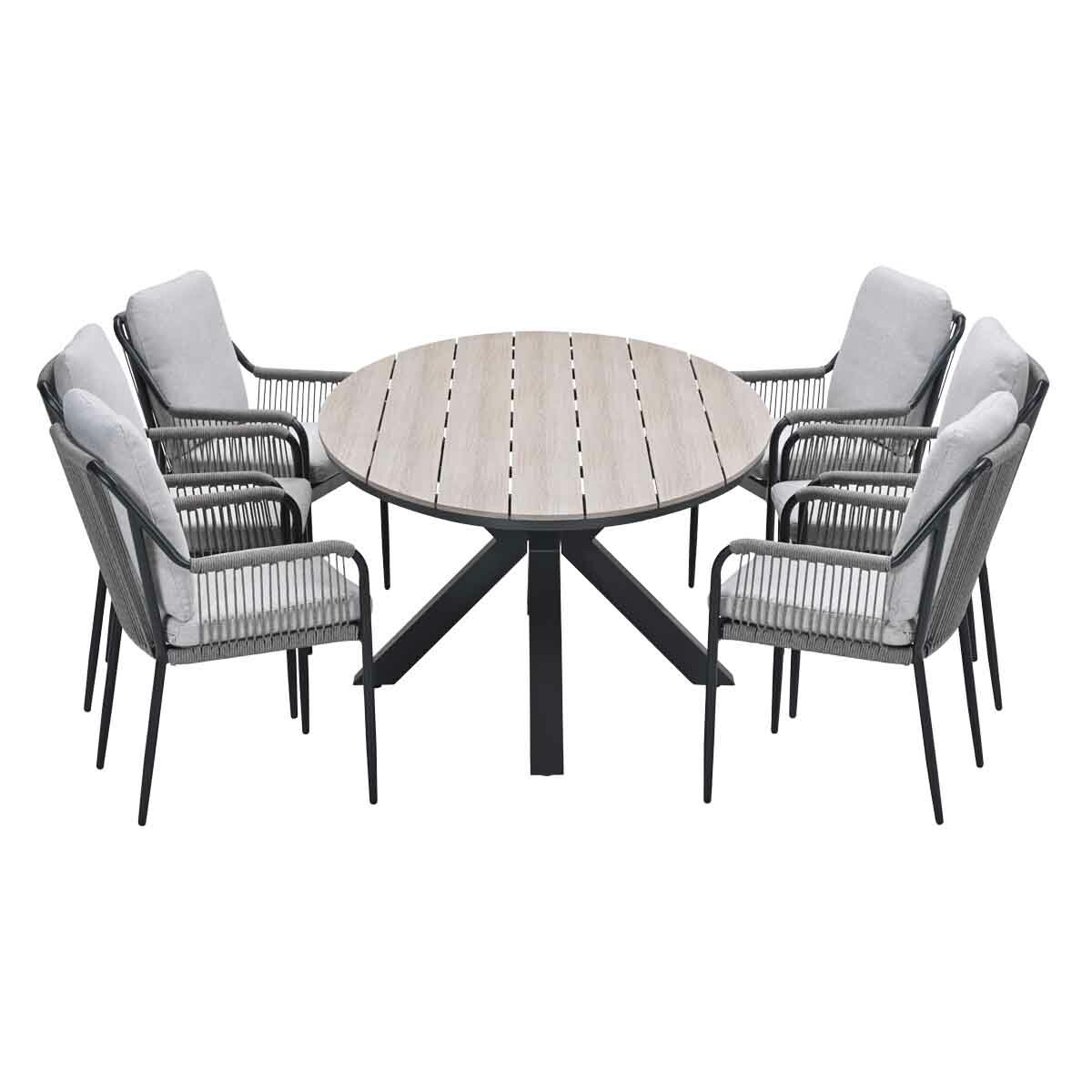 Round outdoor dining table with six chairs. Table has a light wood top and black base. Chairs are gray with cushions.
