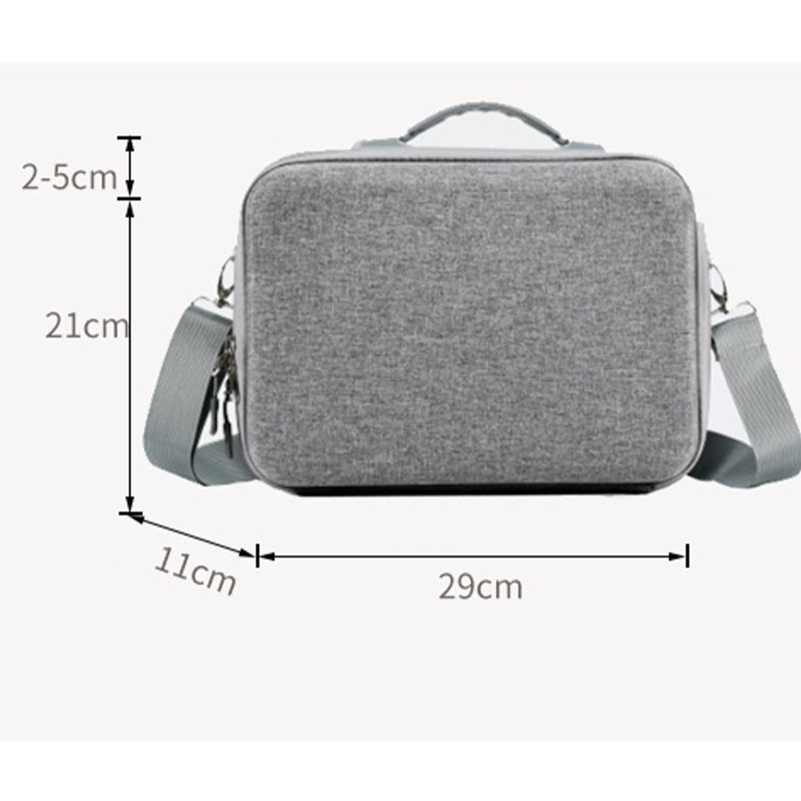 Graue Tasche mit Griff und Riemen. Maße: 21 cm Höhe, 29 cm Breite, 11 cm Tiefe. Messungen sind gezeigt.