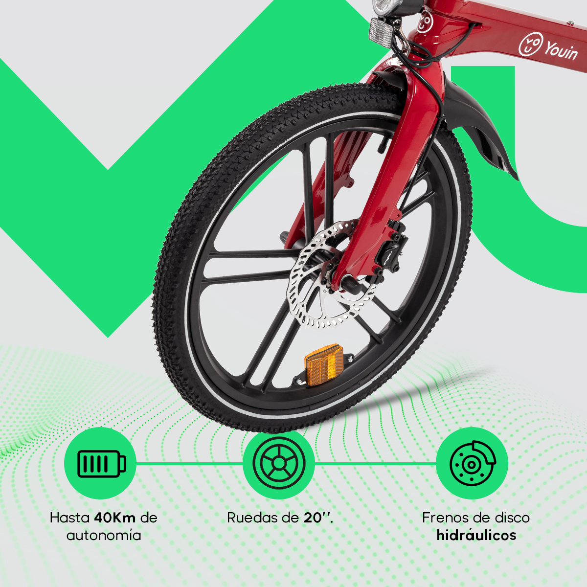 Bicicletta elettrica rossa e nera. Sono visibili la ruota anteriore e la forcella. Il testo indica 40 km di autonomia, ruote da 20" e freni a disco idraulici.