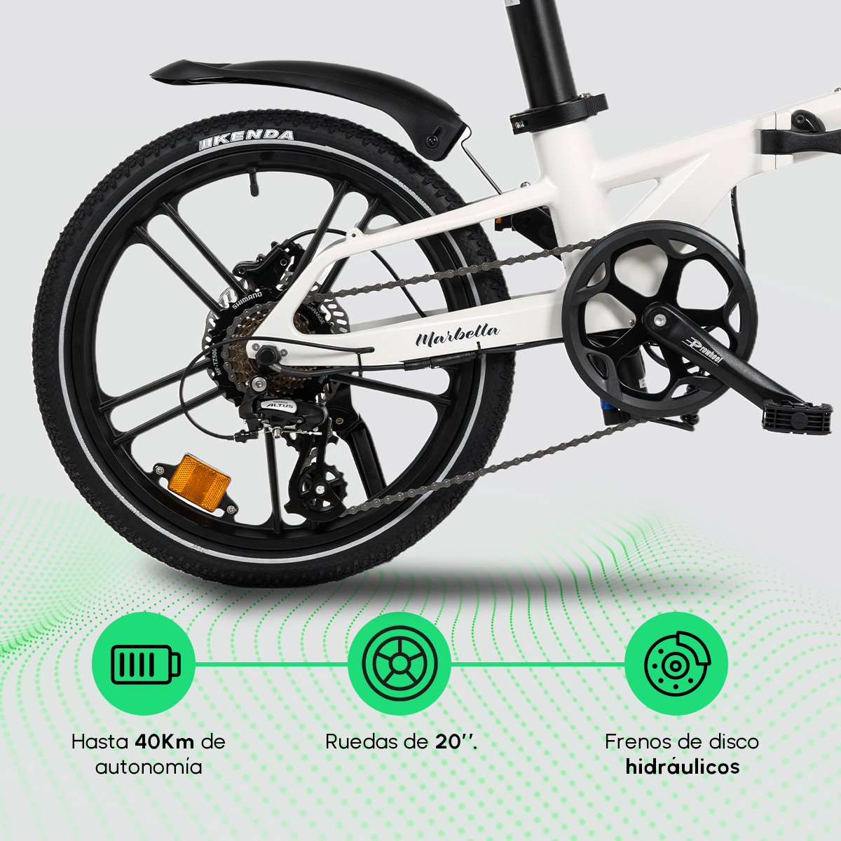 Bicicleta blanca plegable con ruedas negras. Tiene frenos de disco y ruedas de 20". Incluye Shimano, neumáticos Kenda y marca Marbella.