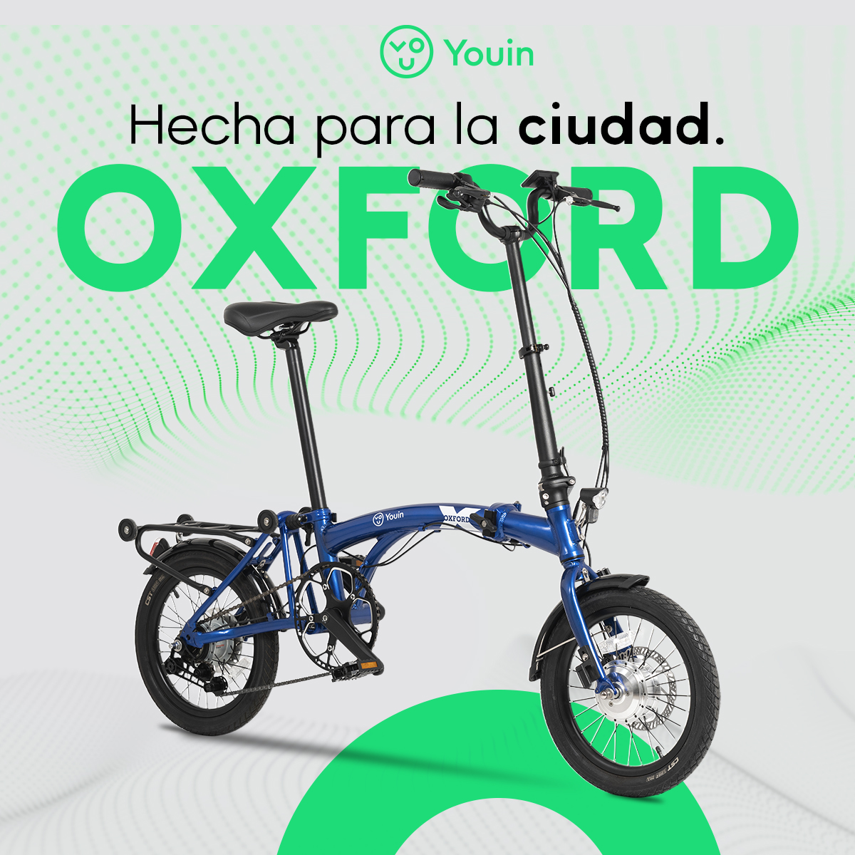 Bicicleta plegable azul con detalles negros, llamada Oxford. Fondo verde con texto. Logotipo Youin arriba a la izquierda.