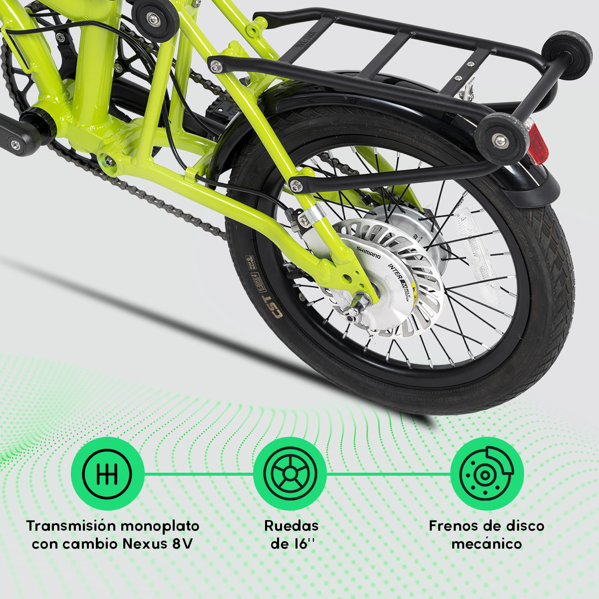 Detalle de bicicleta verde con neumático negro y portaequipajes. Etiquetas muestran transmisión Nexus 8V, ruedas de 16" y frenos de disco mecánicos.