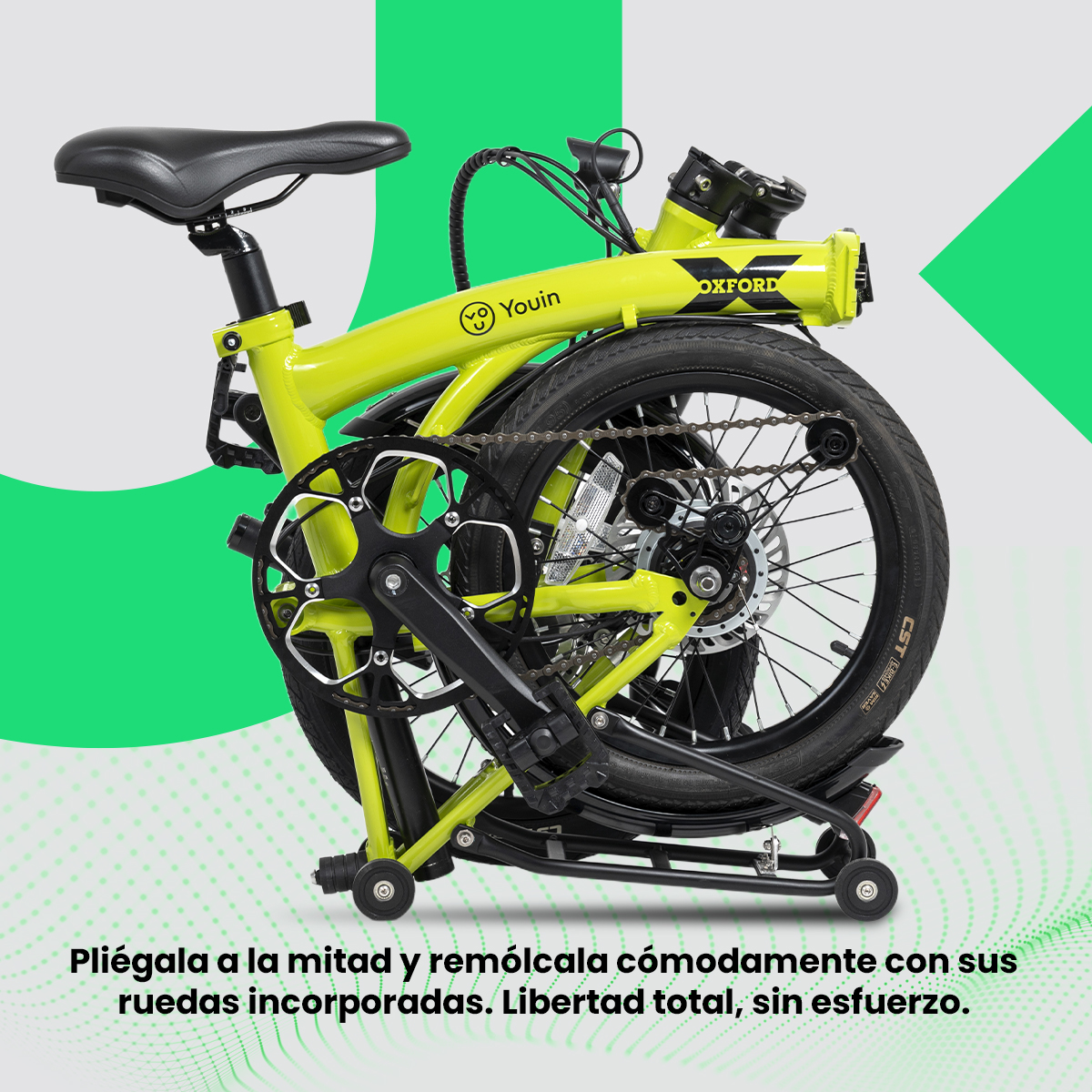 Bicicleta plegable verde lima, neumáticos y asiento negros, plegada. Marcas Youin y Oxford visibles.