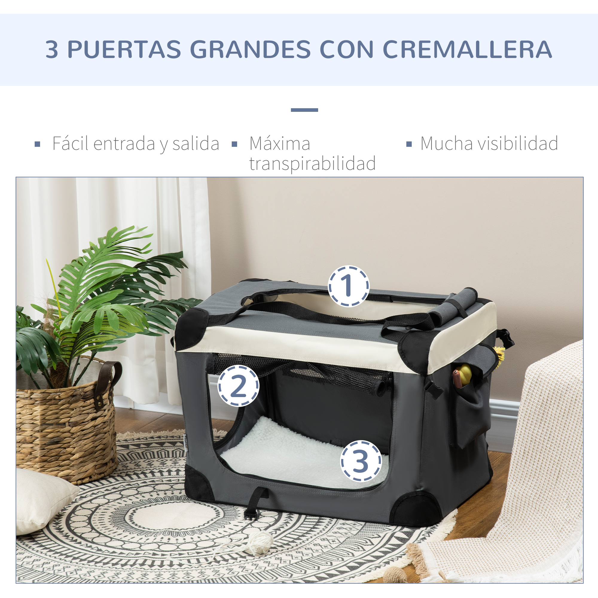 Un transportín gris para mascotas con tres puertas con cremallera. Incluye una cama para perros y un juguete para perros.