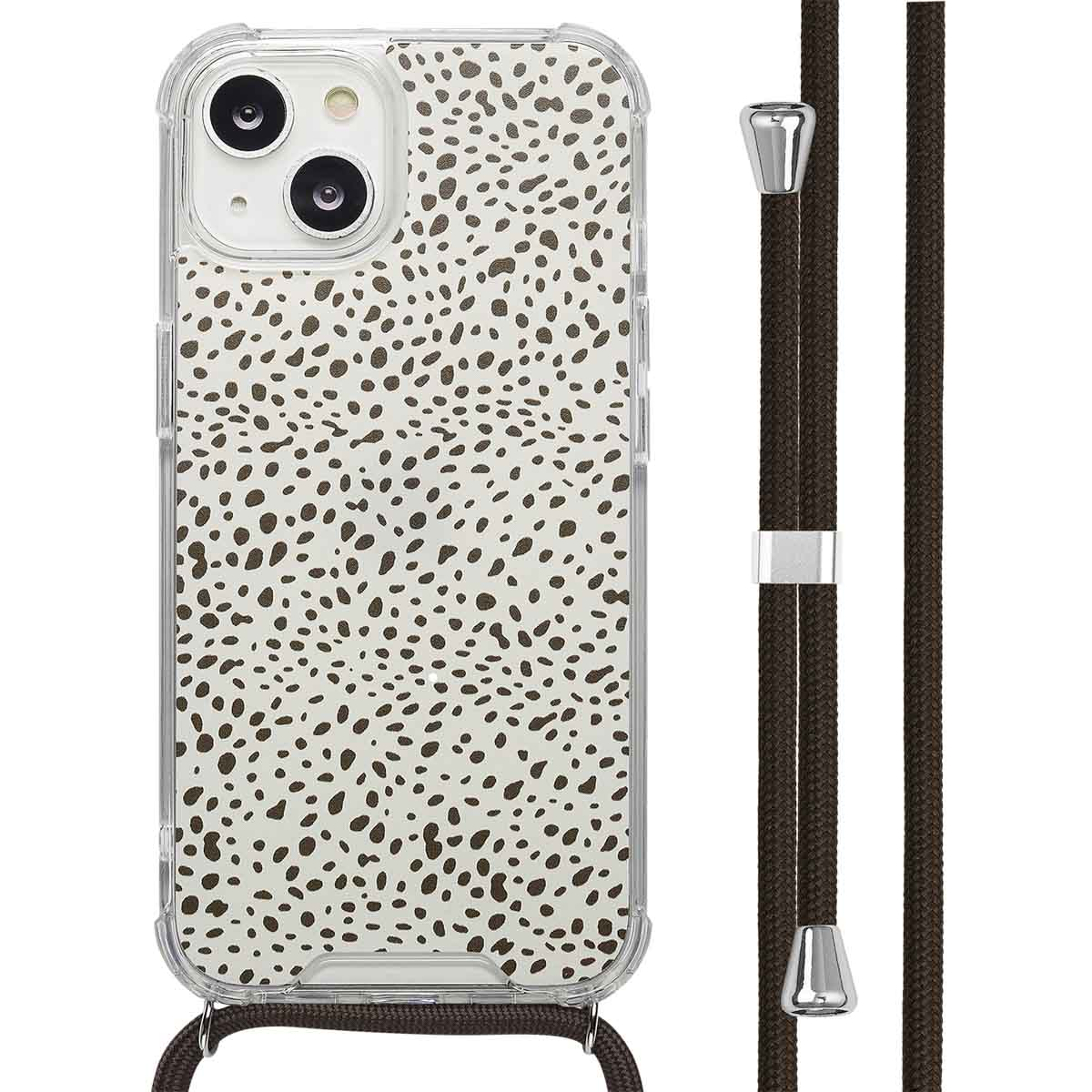Een telefoon met een hoesje met een witte achtergrond met bruine stippen, met een bruin koord.