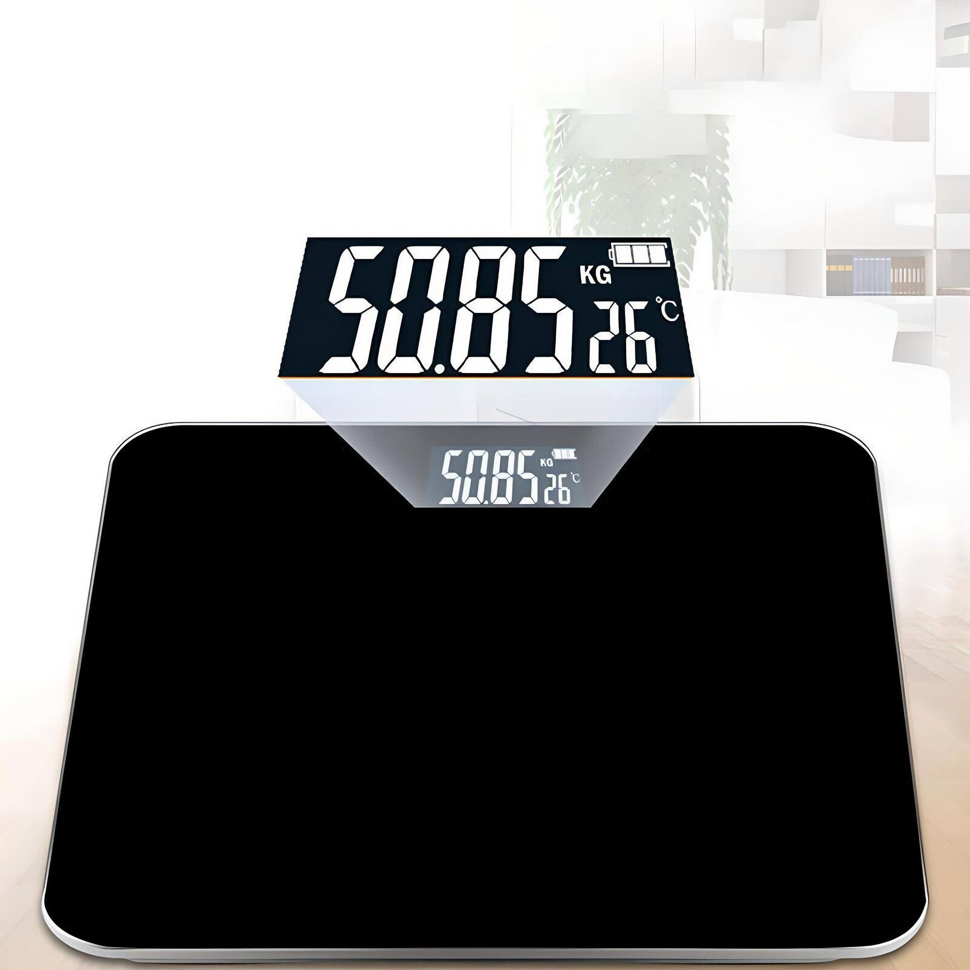 Eine schwarze Digitalwaage mit einer Anzeige von 50,85 kg und 26 Grad Celsius. Sie steht auf einer Holzoberfläche.
