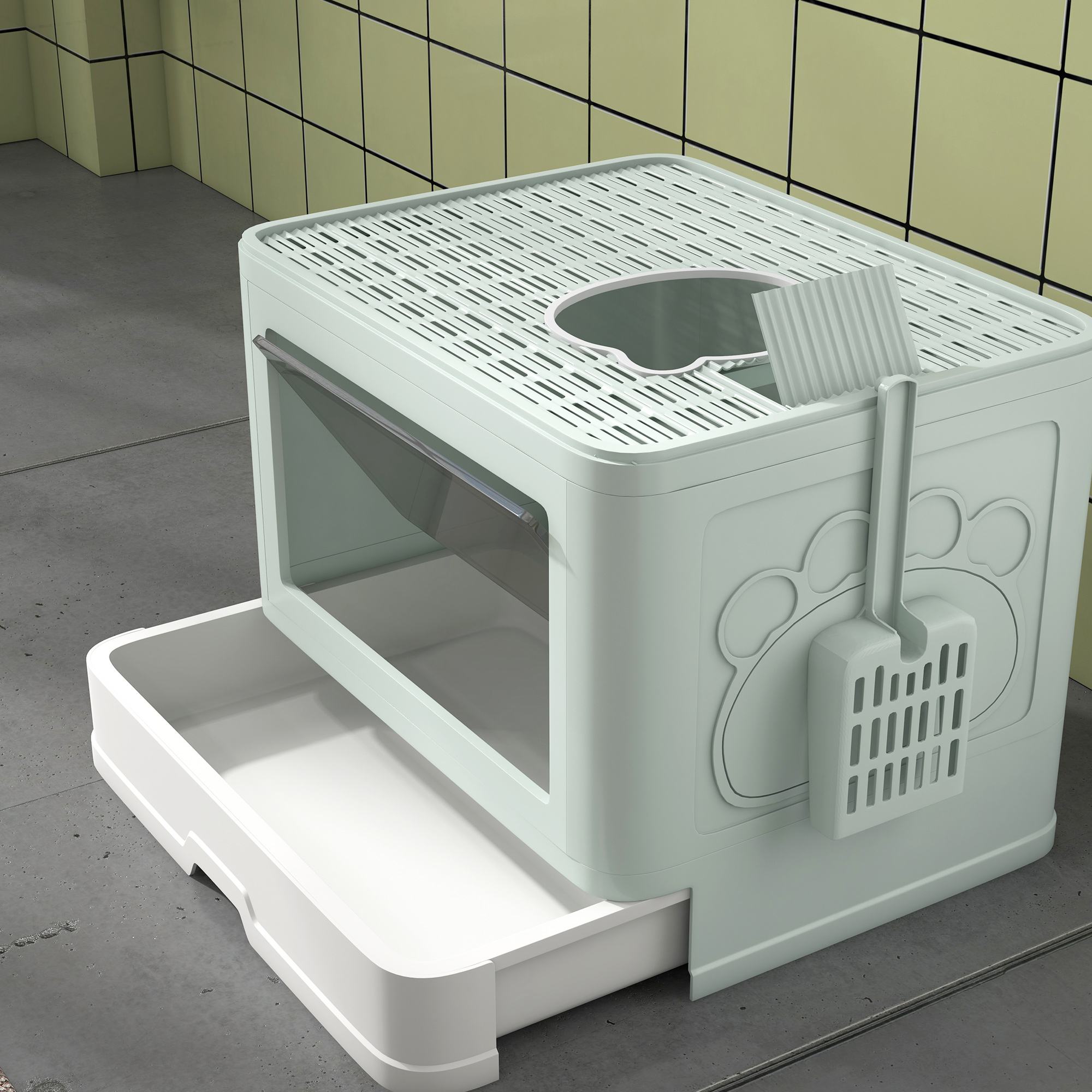 Una lettiera per gatti verde chiaro con una paletta. Ha un ingresso superiore e un cassetto estraibile per pulire.