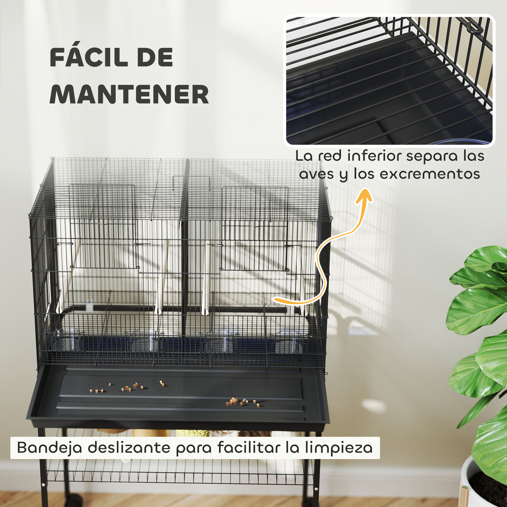 Se muestra una jaula de pájaros negra con una bandeja deslizante para facilitar la limpieza junto a una planta verde.