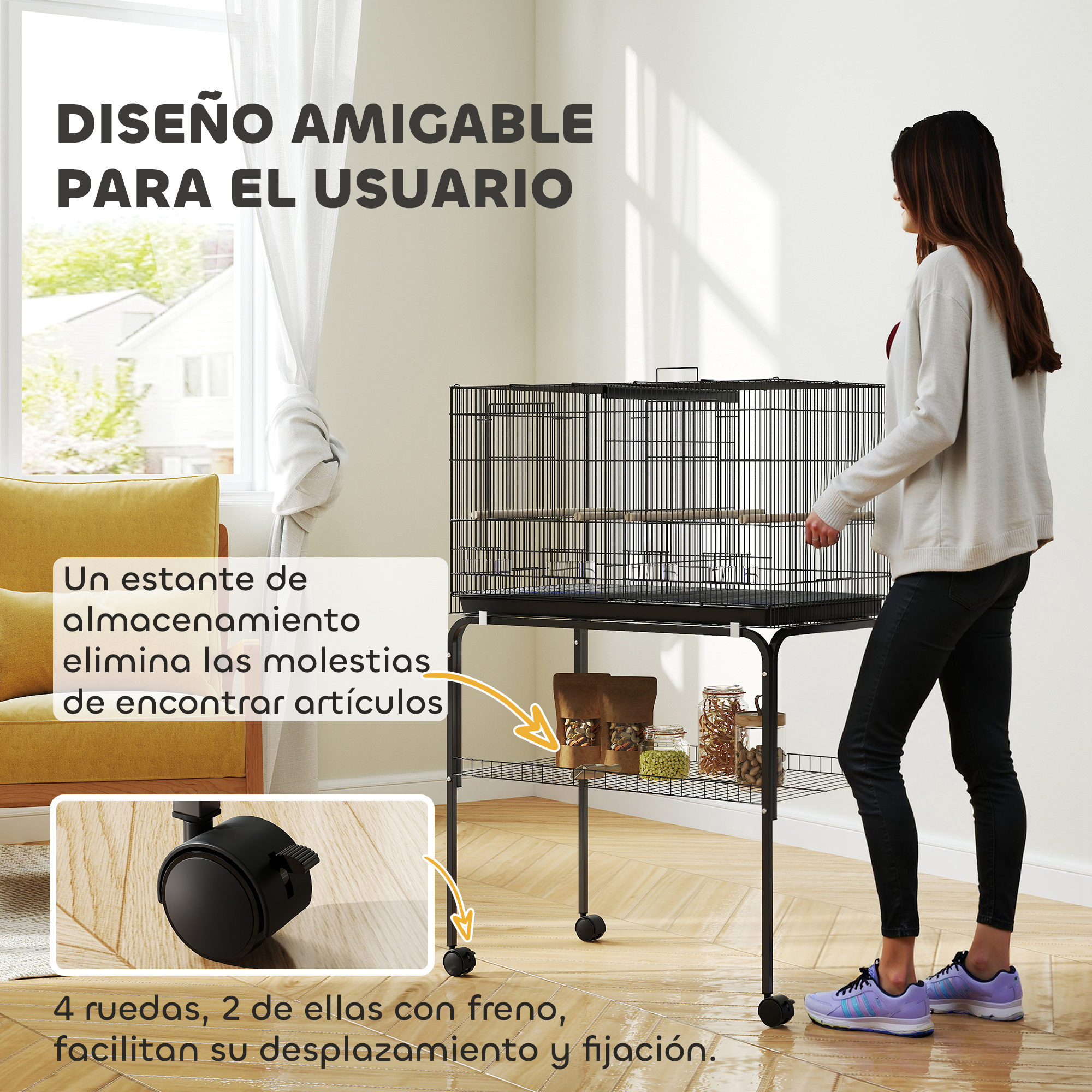 Una mujer está de pie junto a una jaula de pájaros negra con ruedas y almacenamiento debajo, al lado de un sofá amarillo.