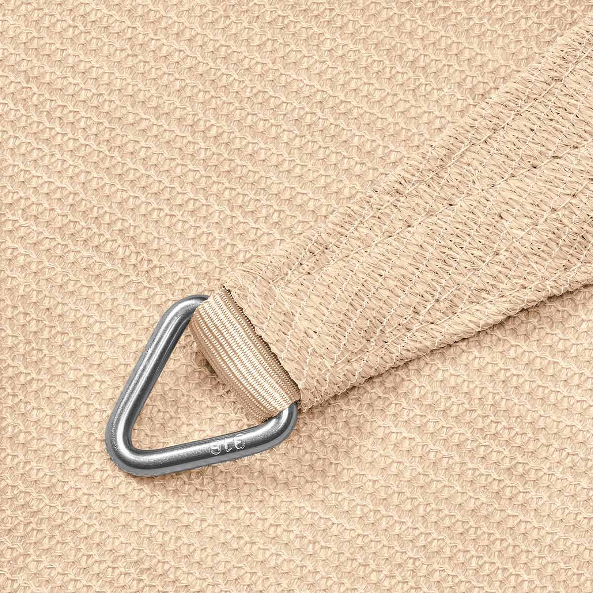Un gros plan d'un coin de voile d'ombrage en tissu beige avec un anneau métallique, montrant sa texture et sa fixation.