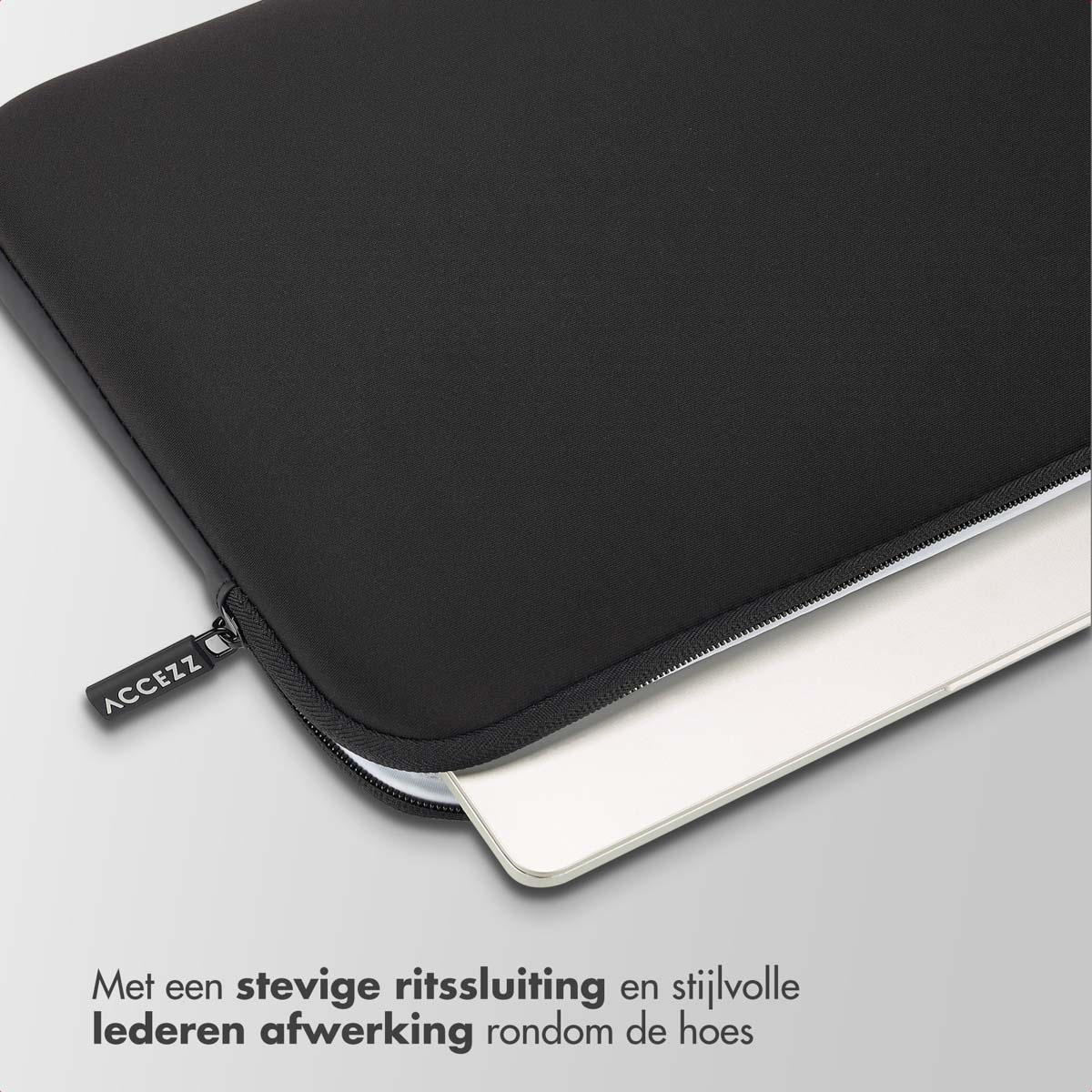 Black laptop sleeve with a zipper and the ACCEZZ logo. A laptop is partially inside the sleeve.