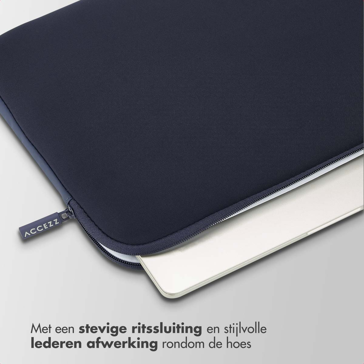 A dark blue laptop sleeve with a white laptop peeking out. The sleeve has a zipper.