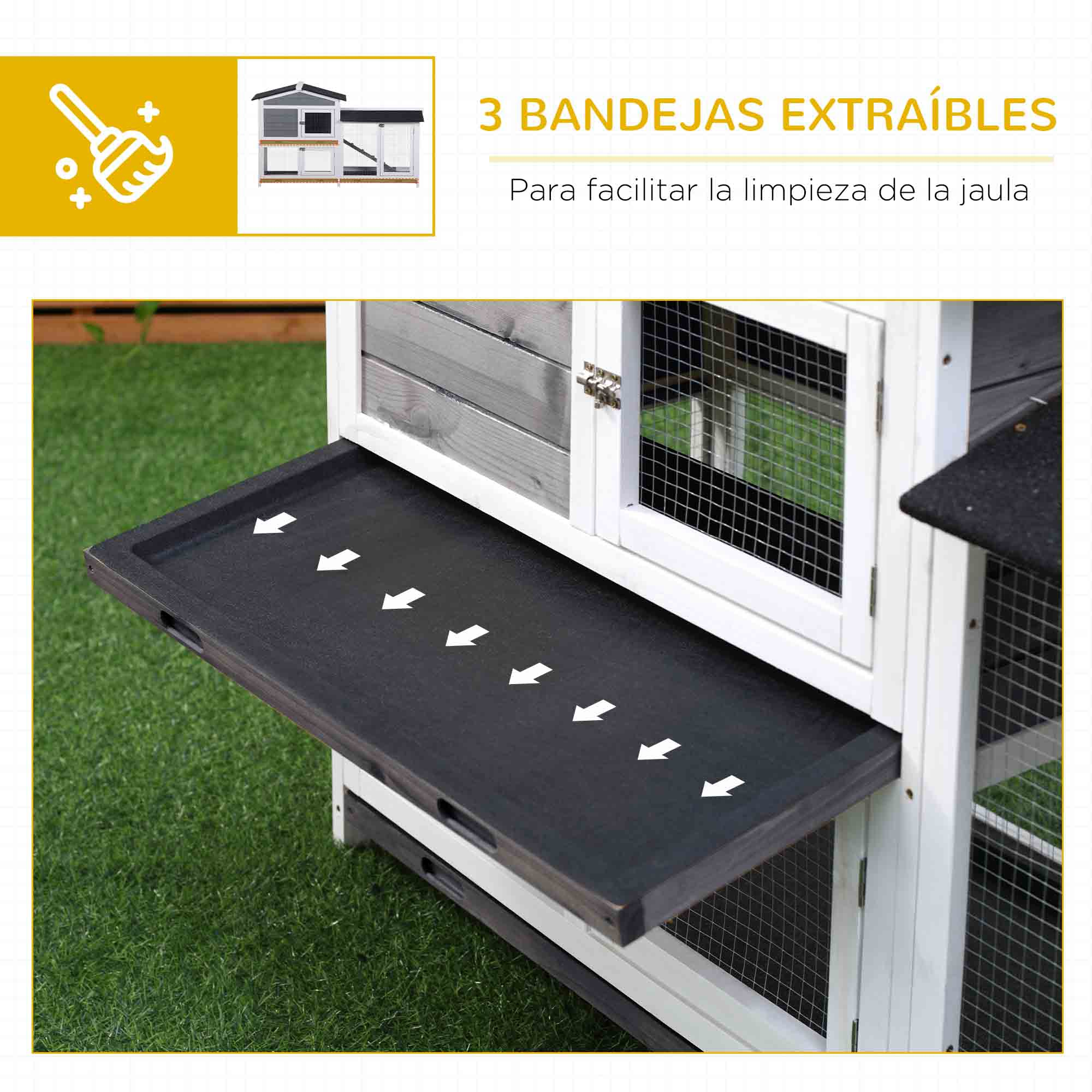 Una casa para mascotas tiene una bandeja extraíble con flechas blancas, sobre un fondo de hierba y blanco.