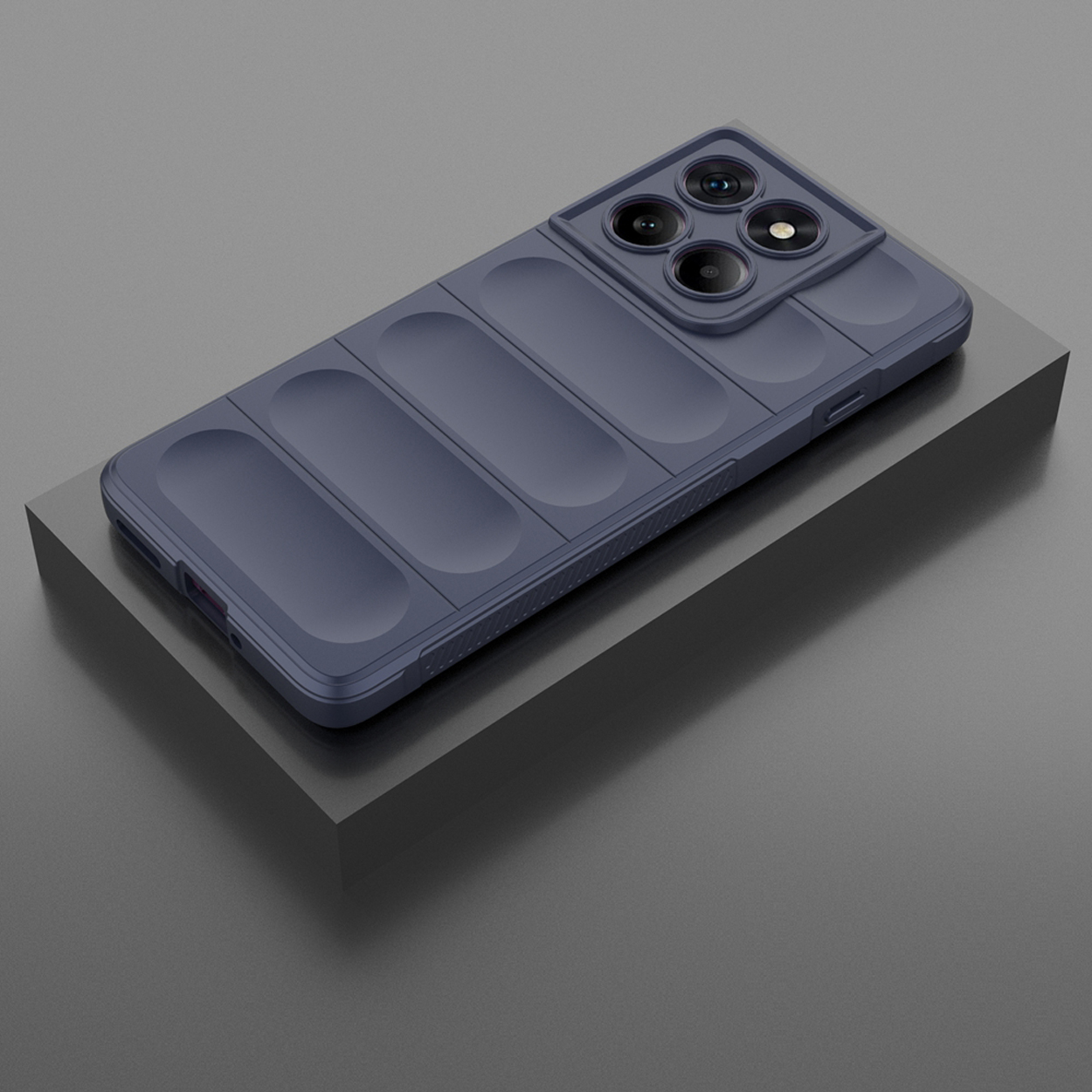 Une coque de téléphone bleu marine sur une surface gris foncé. La coque comporte plusieurs découpes pour l'appareil photo.