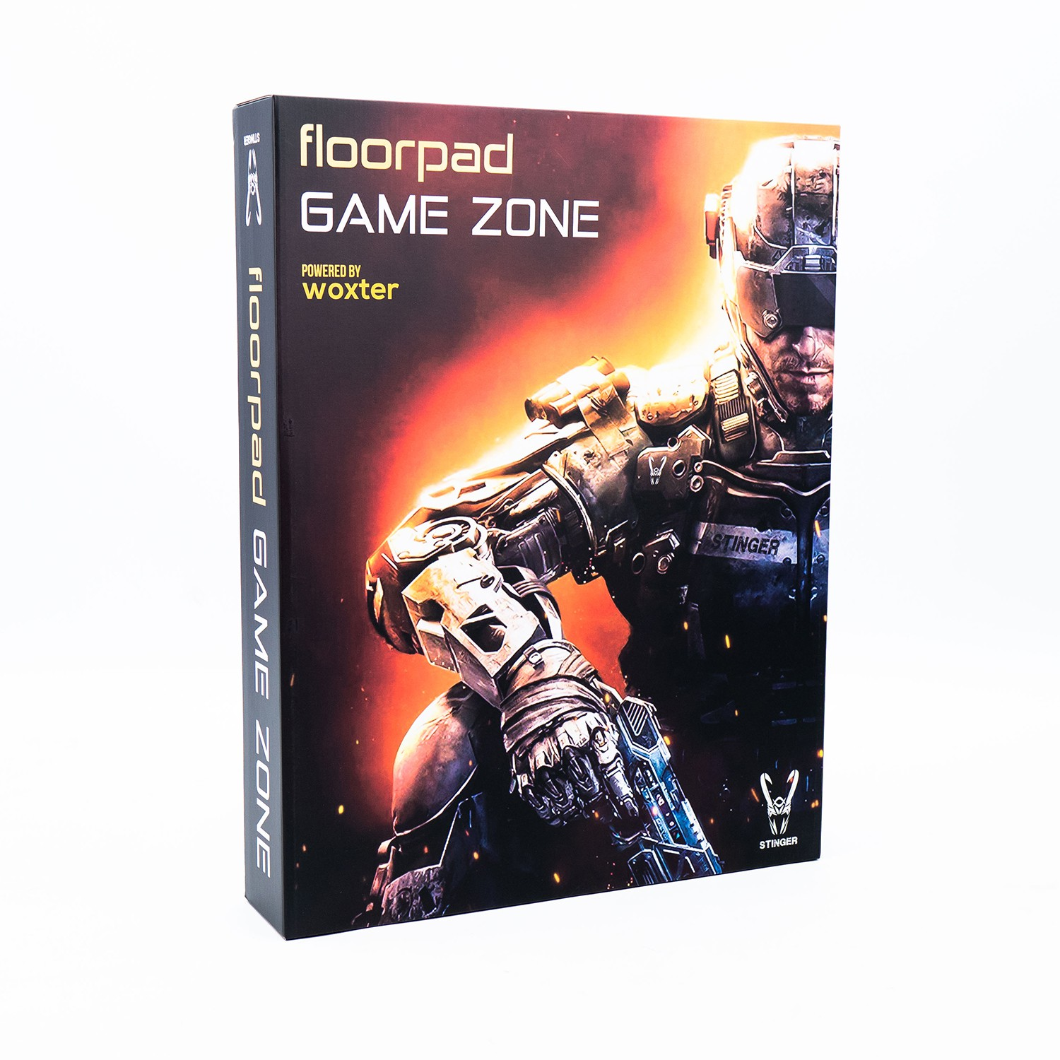 Una caja de juego con un soldado con uniforme negro. La caja dice 'floorpad GAME ZONE' con logo 'woxter'.