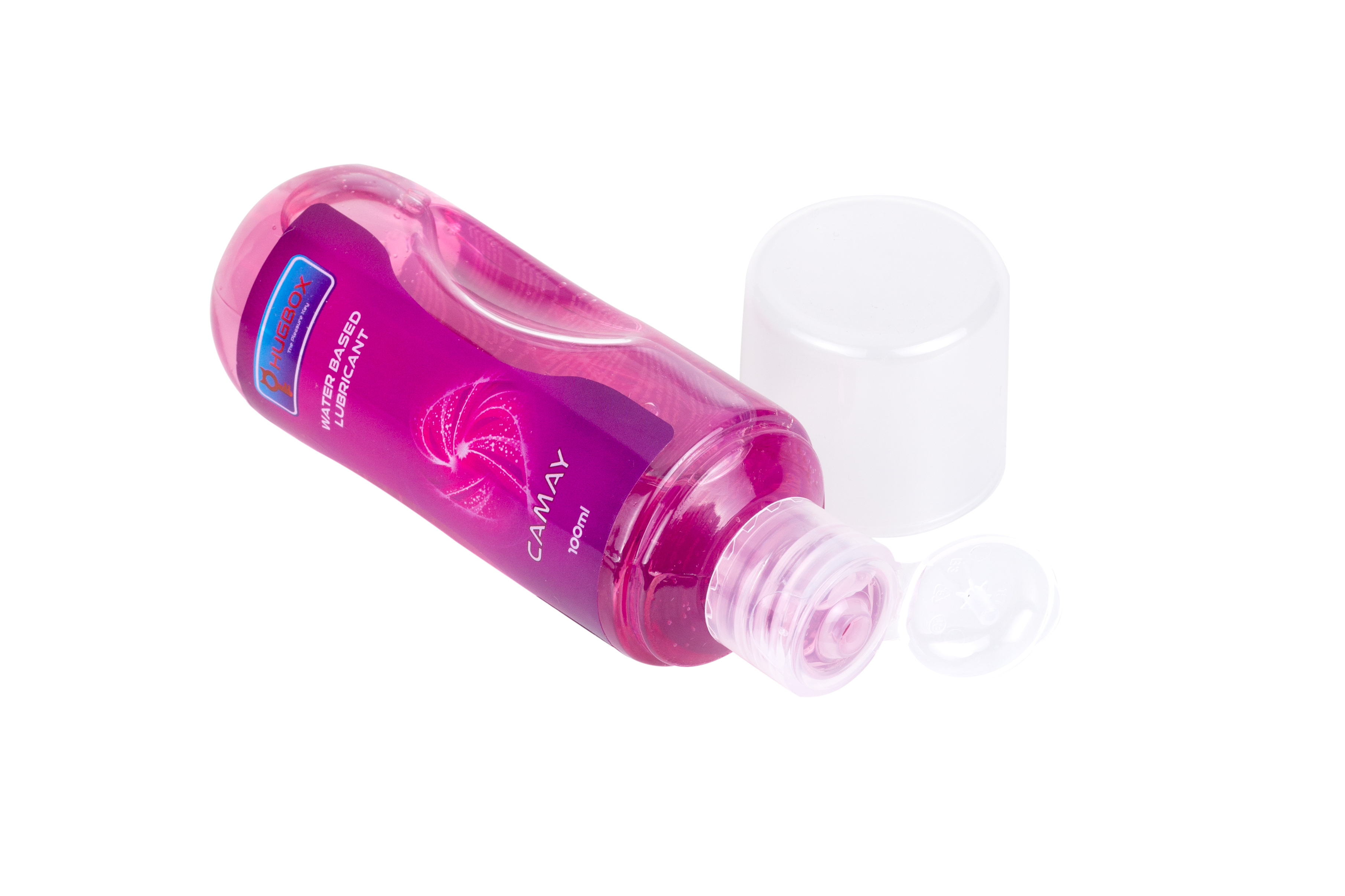 Botella de lubricante rosa, acostada de lado, sin tapa, sobre una superficie blanca.