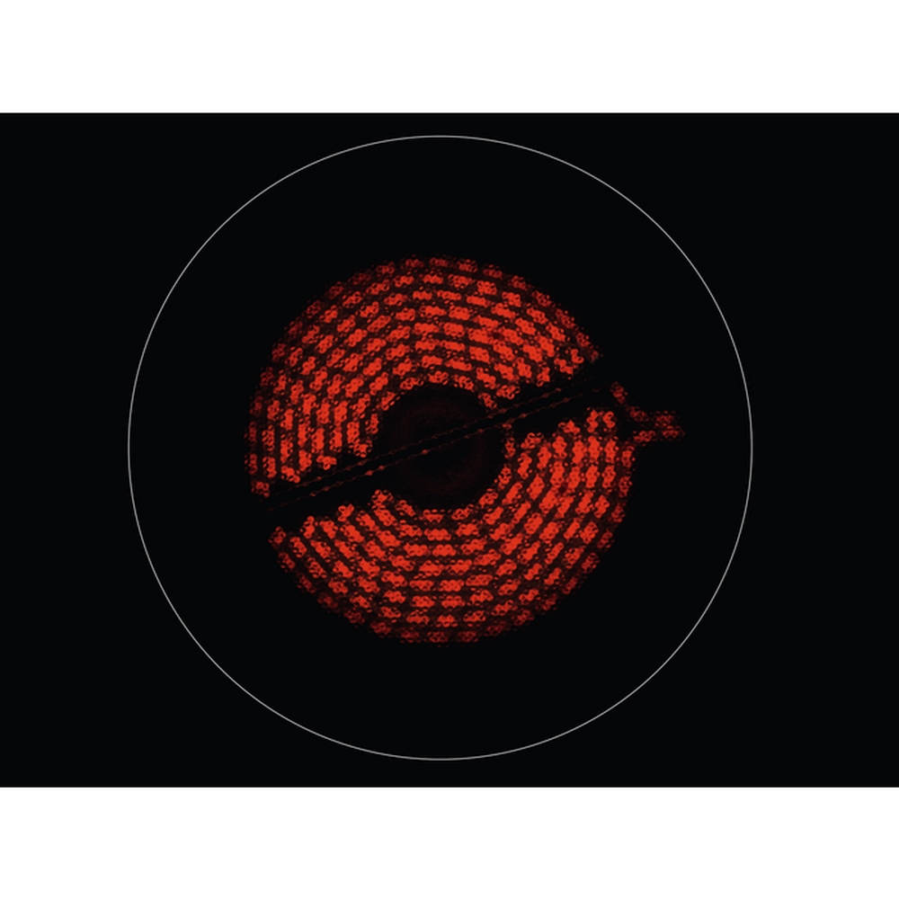 Zbliżenie rozgrzanego na czerwono elementu płyty indukcyjnej o okrągłym wzorze.