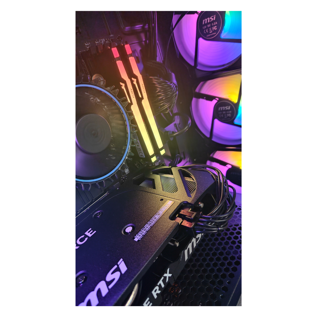 Vista interna del computer: scheda grafica, moduli RAM, dissipatore CPU e ventole con luci colorate.