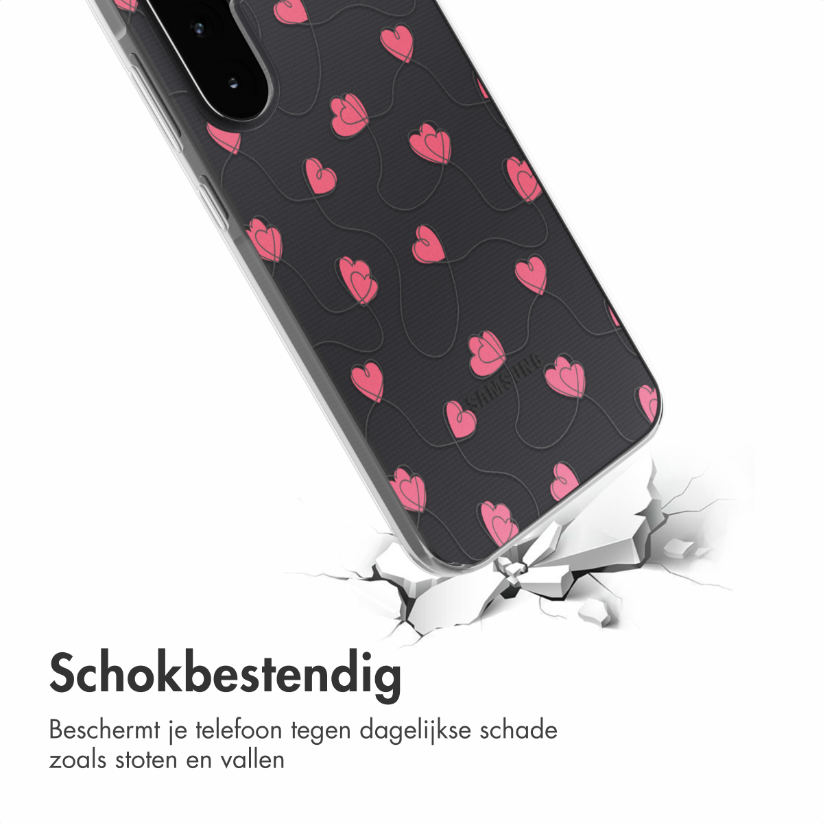 Een telefoonhoesje met roze hartjes op zwarte achtergrond staat schuin, lijkt te vallen, met een gebarsten grond eronder.