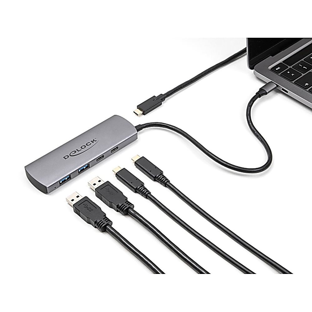 Un hub argentato con più porte USB e USB-C collegato a un laptop con cavi.