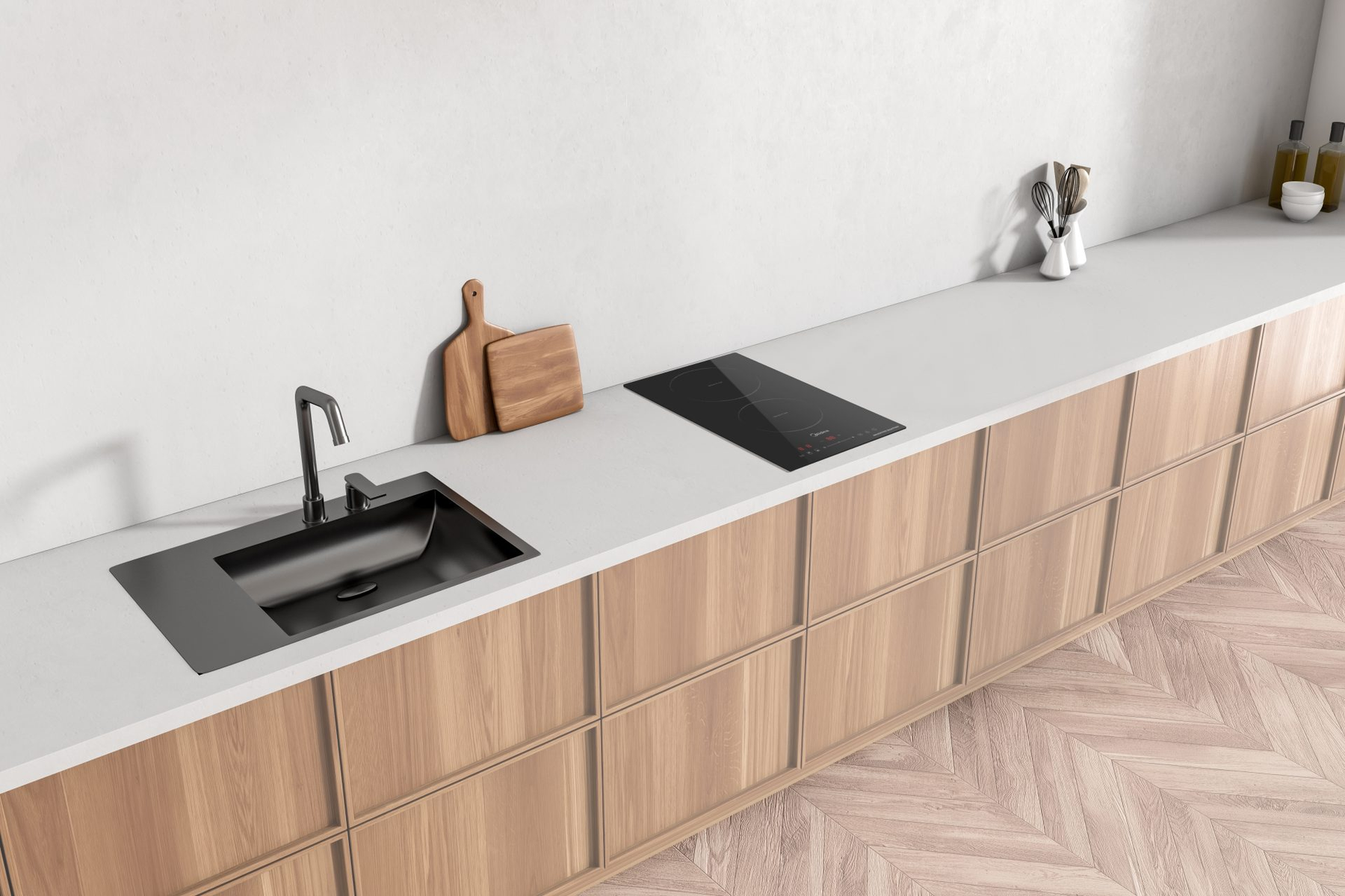 Un piano cucina con lavello, piano cottura e taglieri in legno. Visibili mobili e pavimenti in legno chiaro.