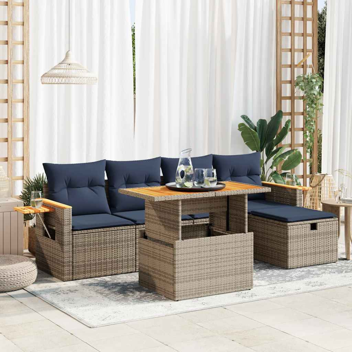 Rattan-Sofa-Set für den Außenbereich mit Tisch, Kissen und Deko.
