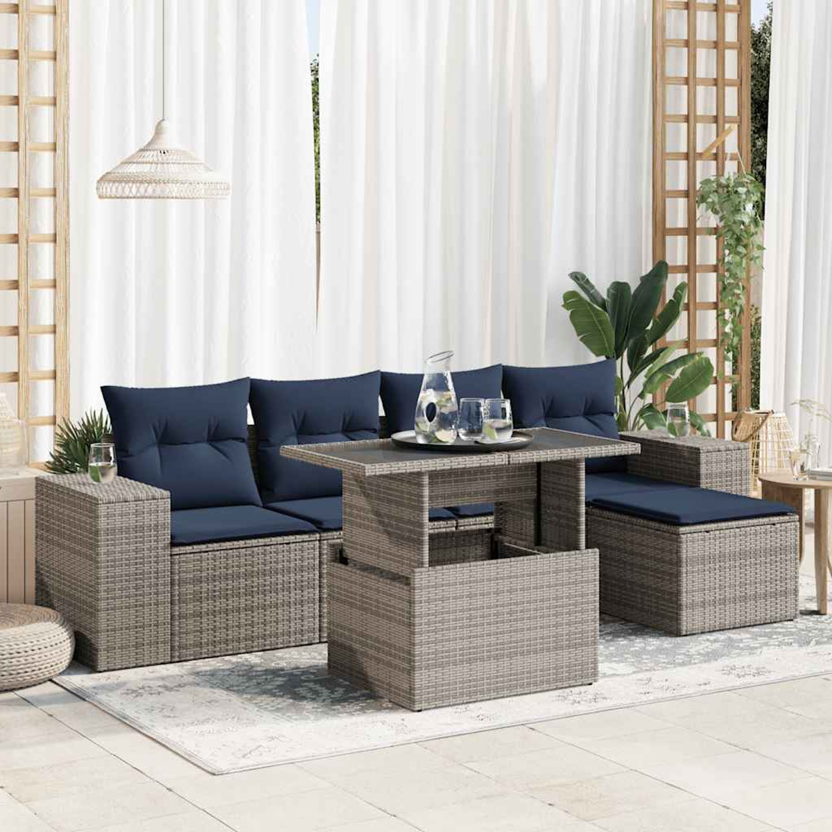 Graues Ecksofa aus Korbgeflecht mit marineblauen Kissen und einem Tisch mit hebbarer Platte. Set auf Teppich.