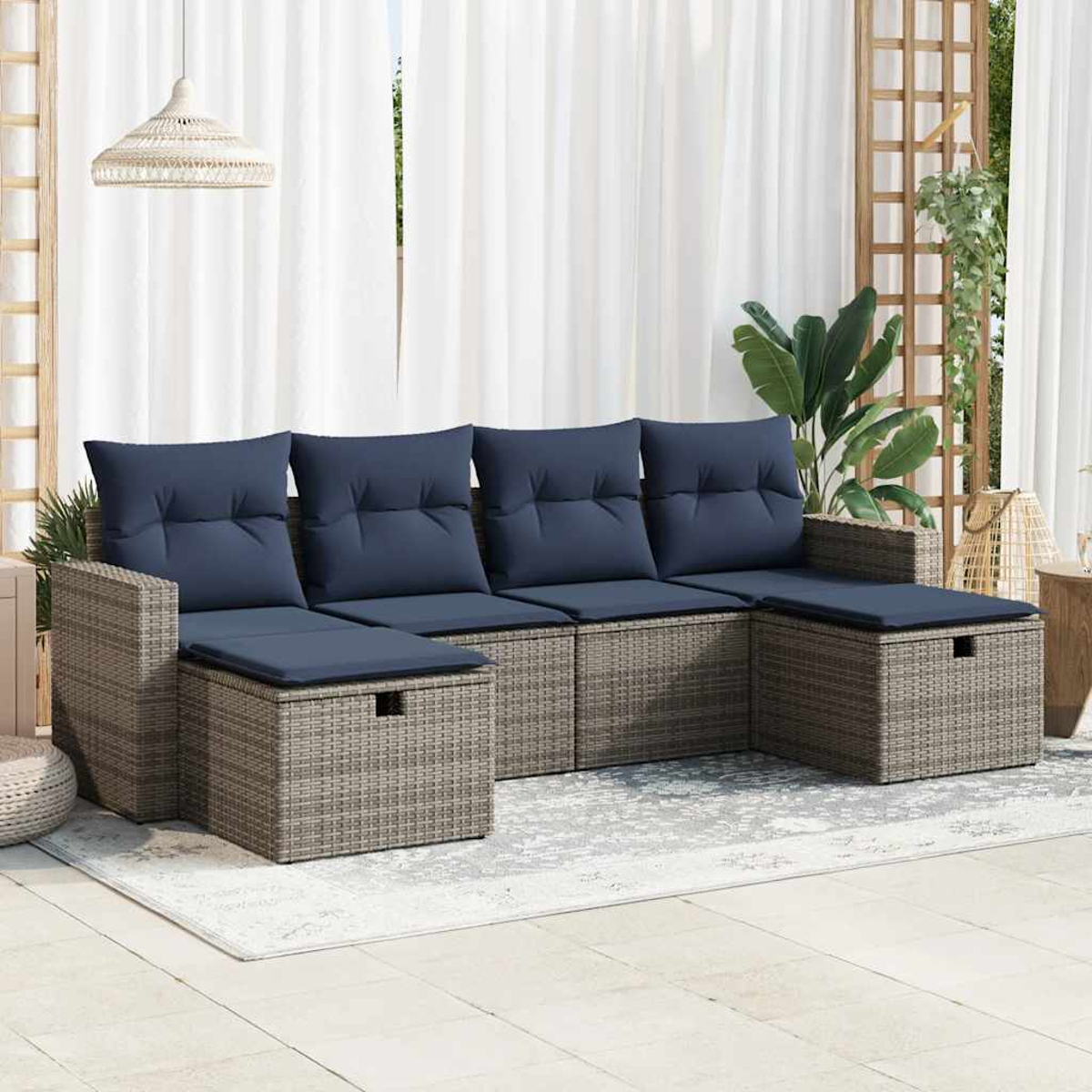 Outdoor-Ecksofa mit blauen Kissen und einem grauen Korbgeweberahmen auf einer Terrasse.