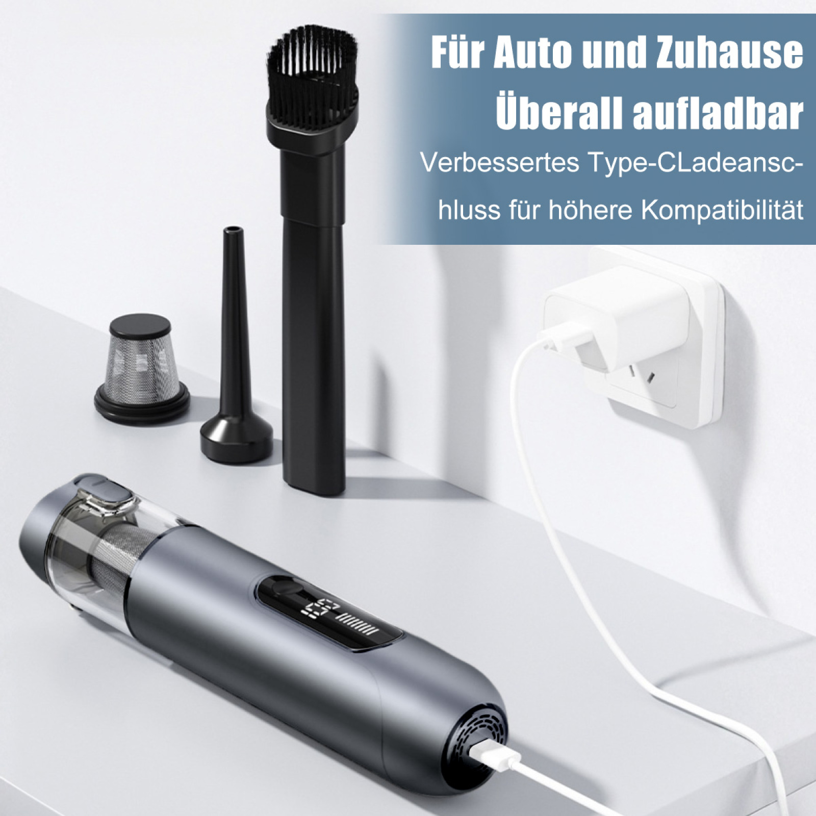 Ein Staubsauger mit Aufsätzen, der mit einem weißen Stecker im Hintergrund geladen wird.