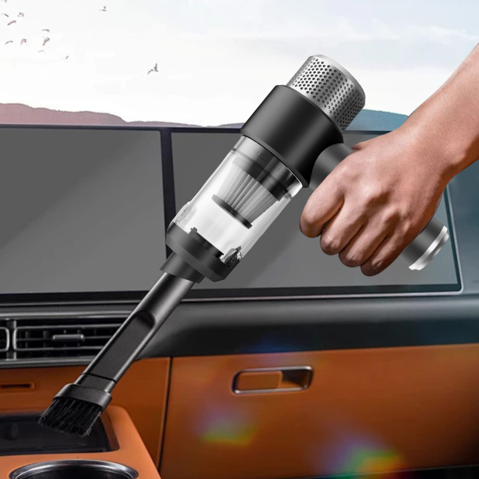 Hand hält einen schwarzen Staubsauger, der einen Autoinnenraum reinigt.