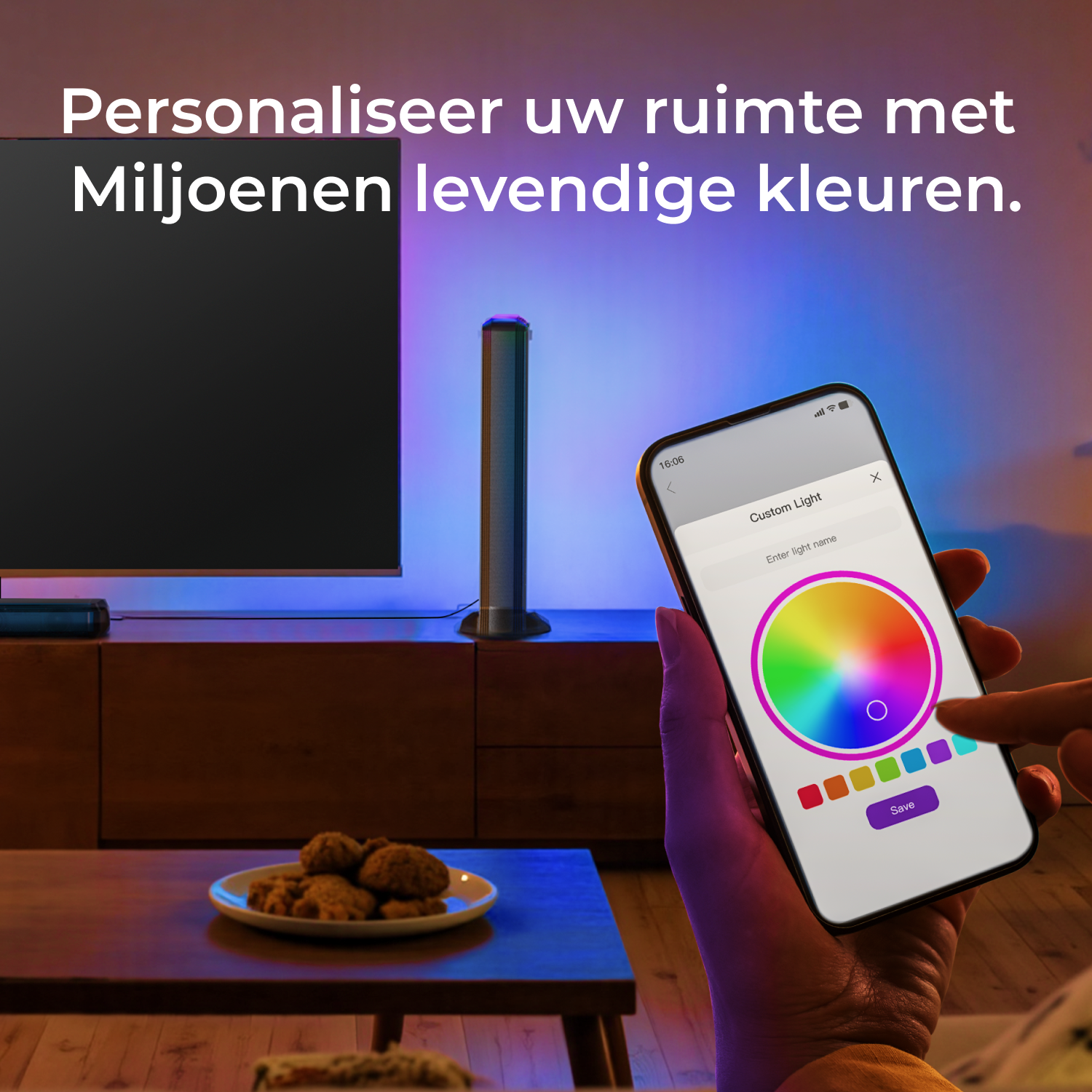 A person holding a smartphone displaying a color wheel for custom light settings, with a TV and lights in the background.