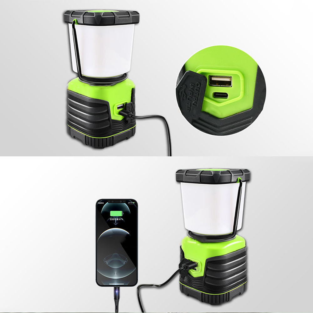 Grüne und schwarze Laterne mit einem ladenden Telefon. Das Telefon ist über ein USB-Kabel verbunden.