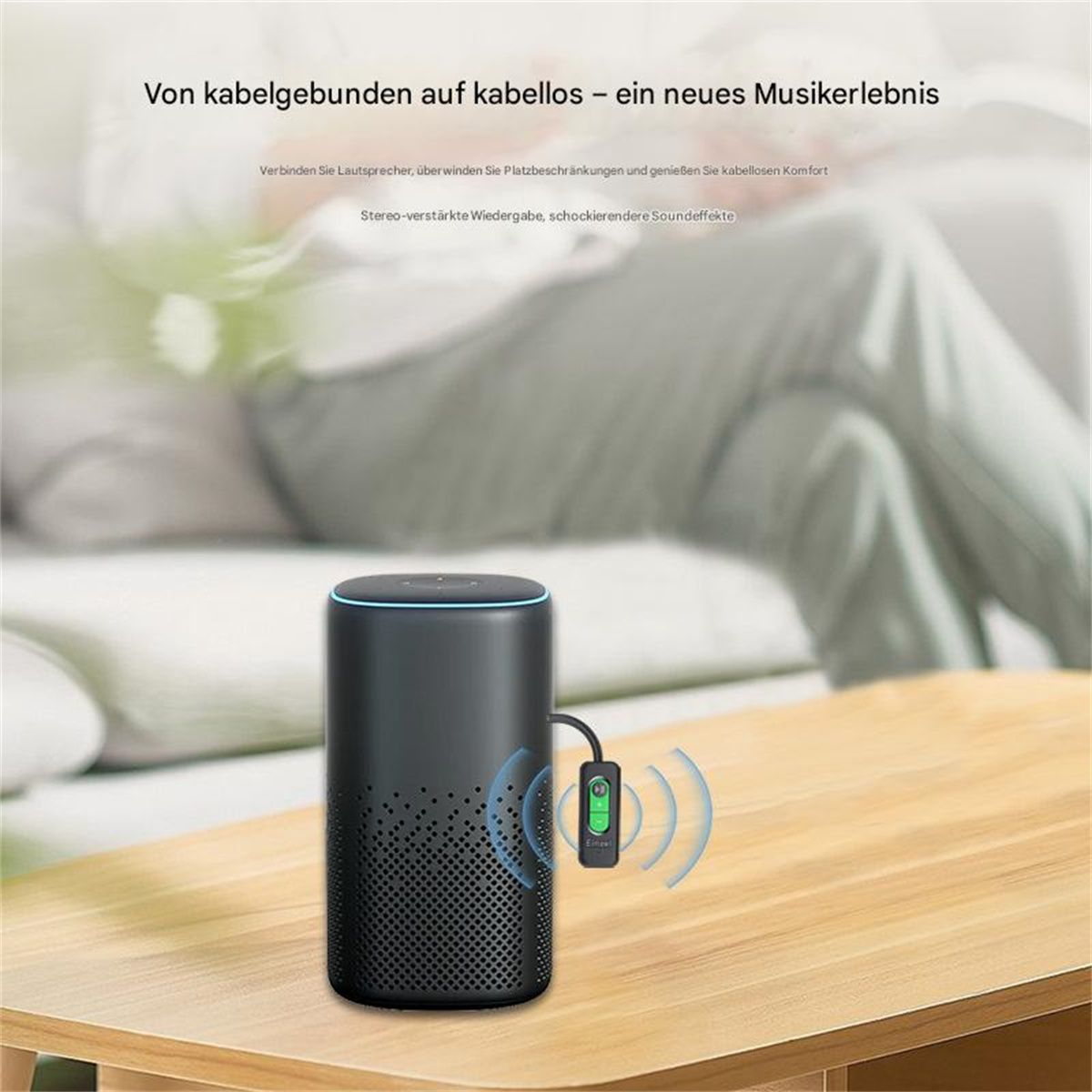 Ein schwarzer Lautsprecher mit angeschlossenem Bluetooth-Empfänger. Die Szene spielt auf einem Holztisch.
