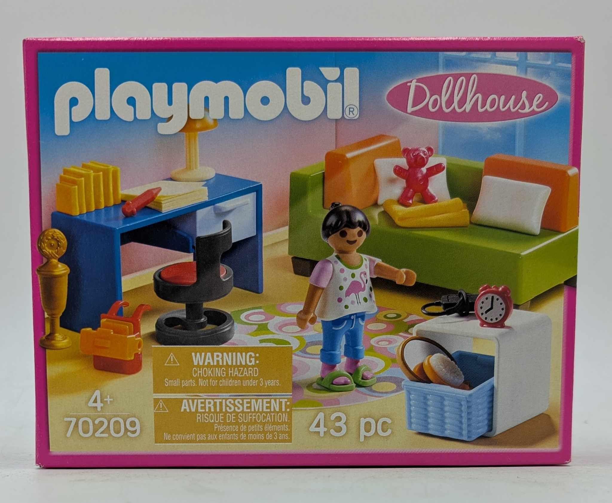 Pudełko z domkiem dla lalek Playmobil. Widoczna lalka i meble. Różowe pudełko z tekstem i obrazkami.