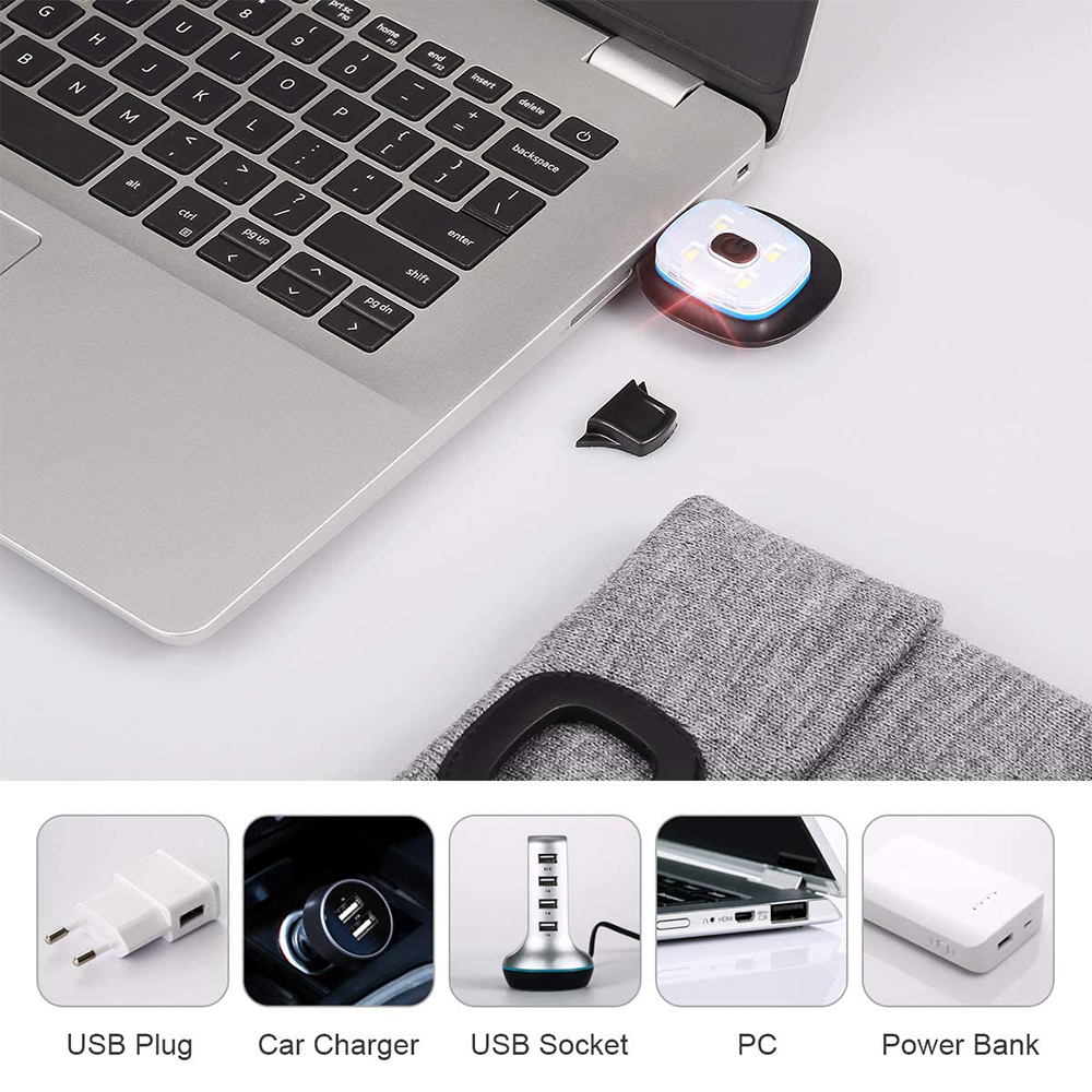 Laptop mit eingestecktem USB-Gerät und verschiedenen USB-Zubehörteilen. Weißer Hintergrund.