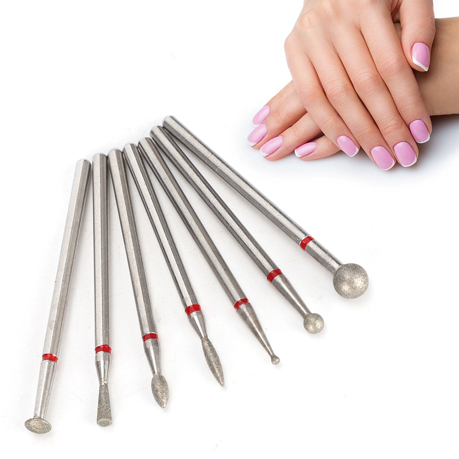 Zahnbohrer neben einer Hand mit rosa lackierten Nägeln.