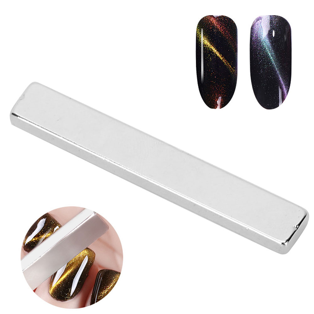 Ein silberner rechteckiger Magnet mit Nagellackproben und Werkzeugen für einen Cat-Eye-Effekt.